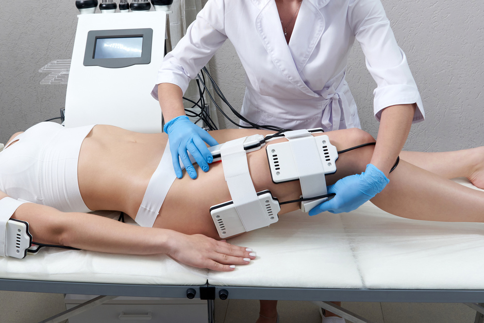 Beautiful Woman Getting Electro Stimulation . Laser Lipo Equipment. Cosmetic Fat Reduce Treatment. anti Cellulite Procedure